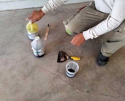 Concrete fortification material and simple tools are used to fill cracked concrete